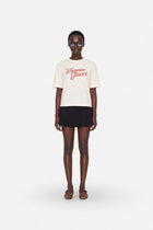 Oversized cream cotton T-shirt by Ginaci Türkiye, casual fit, soft fabric, relaxed style, displayed on a hanger.