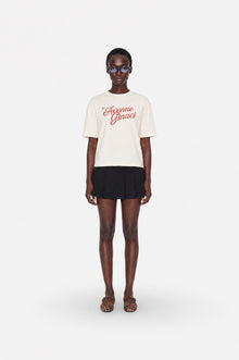 Oversized cream cotton T-shirt by Ginaci Türkiye, casual fit, soft fabric, relaxed style, displayed on a hanger.