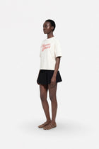 Cream oversized cotton T-shirt from Ginaci Türkiye, showing a relaxed fit and soft fabric detail.
