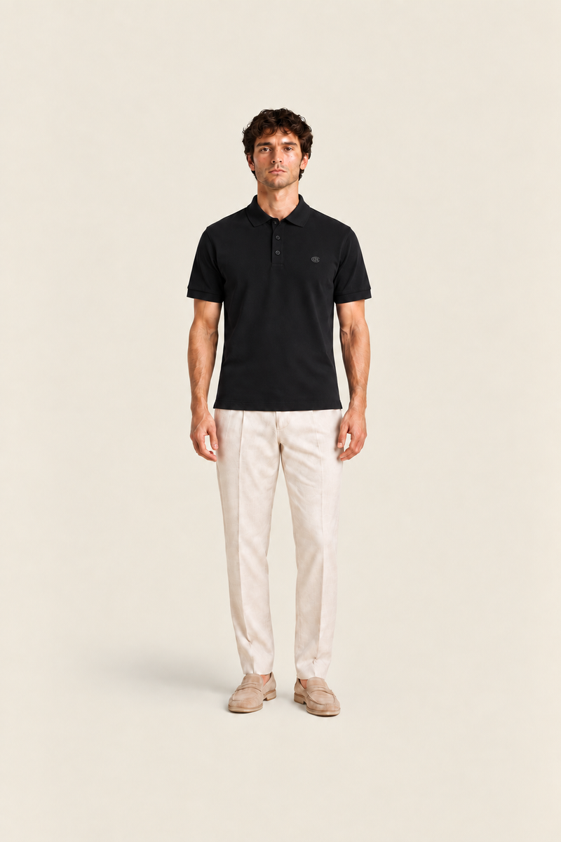 Black polo shirt from Ginaci Türkiye featuring a classic fit and short sleeves, shown from the front view.